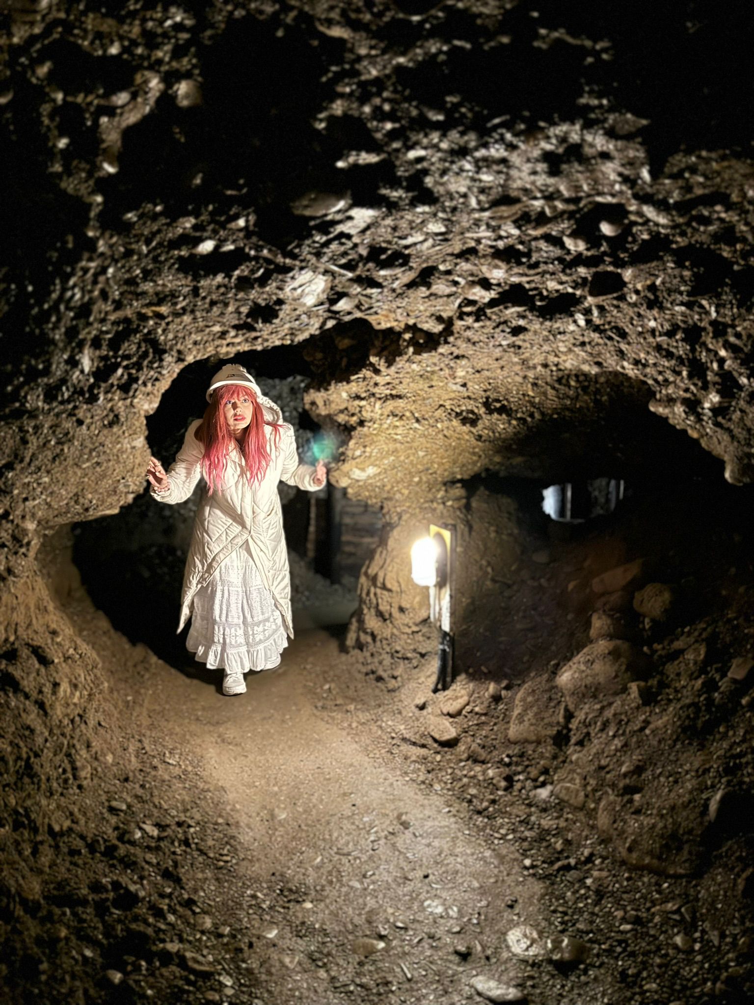 Mujer de cabello rosa en una cuva en las piramides de bosnia en un retiro espiritual